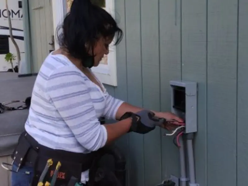 Licensed electrician wiring an exterior subpanel in Evanston